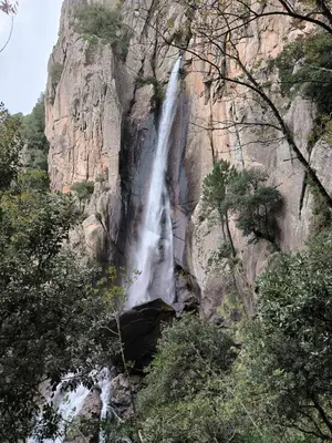 a waterfall on the side of a rocky mountain at Port de Bonifacio in Bonifacio