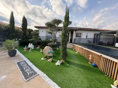 a yard with toy figurines on the grass next to a pool at Villa avec piscine 8 personnes in Porto-Vecchio