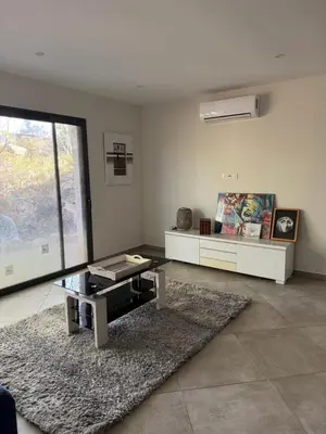 a living room with a table and a rug at Casa di u Fiume in Peri