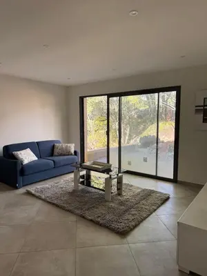 a living room with a blue couch and a table at Casa di u Fiume in Peri