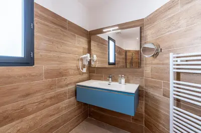 a bathroom with a sink and a mirror at Villa U Veniqui 2 - Piscine privée in Conca
