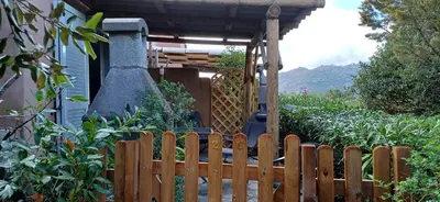 a wooden fence in front of a house at Mini villa 200 mètres de la plage de Santa Guilia in Porto-Vecchio