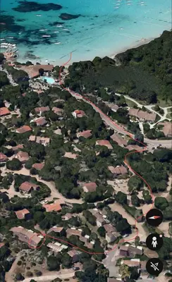 an aerial view of a road with houses and the ocean at Mini villa 200 mètres de la plage de Santa Guilia in Porto-Vecchio