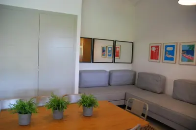 a living room with a couch and a table at Mini Villa Santa in Porto-Vecchio