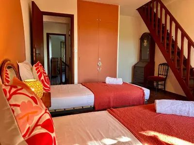 a hotel room with two beds and a staircase at Villa Caline, 4 chambres, lotissement calme et proche mer in Lucciana