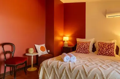 a bedroom with a bed with towels on it at Villa Caline, 4 chambres, lotissement calme et proche mer in Lucciana