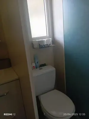 a bathroom with a white toilet and a window at Bungalow charmant à Sorbo-Ocagnano avec jardin in Sorbo-Ocagnano