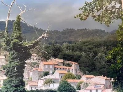 a town on a hill with houses and trees at Casa Marie in Sampolo
