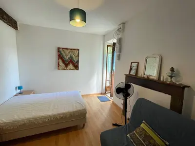 a bedroom with a bed and a mirror and a couch at Casa Marie in Sampolo
