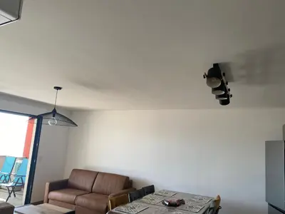 a living room with a couch and a table at appartement ajaccio in Ajaccio