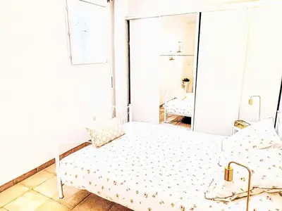 a white bed in a room with a mirror at Holiday Home Casa Orsoni 100m² by Interhome in Cannella