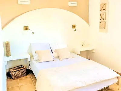 a white bed with two pillows in a room at Holiday Home Casa Orsoni 100m² by Interhome in Cannella