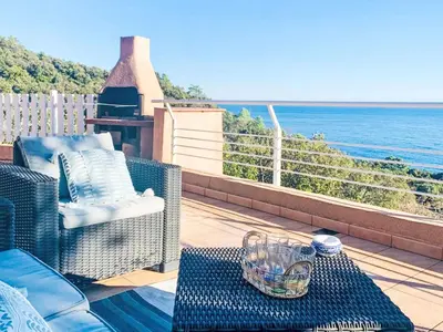 a balcony with a table and a view of the ocean at Holiday Home Casa Orsoni 100m² by Interhome in Cannella