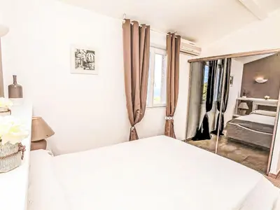 a white bedroom with a bed and a window at Holiday Home Casa Orsoni 80m² by Interhome in Cannella