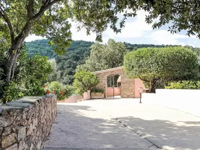 a building with a stone wall next to a driveway at Holiday Home Casa Orsoni 80m² by Interhome in Cannella