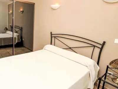 a bedroom with a bed and a mirror at Holiday Home Casa Orsoni 80m² by Interhome in Cannella