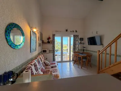 a living room with a couch and a table at CYRNEA 27- Plage à pieds - Clim-Wifi- Favone in Conca