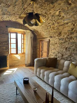 a living room with a couch and a table at Village House With Character In Corsica in Scolca