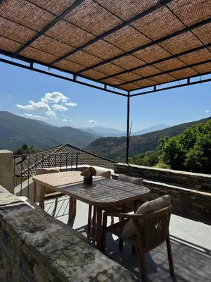 a table and chairs on a balcony with a view at Village House With Character In Corsica in Scolca