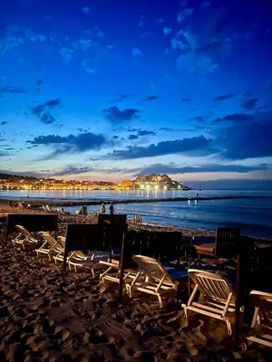 a group of chairs on a beach at night at bel appartement vue montagne proche bastia in Borgo