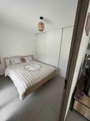 a bedroom with a bed in a white room at bel appartement vue montagne proche bastia in Borgo