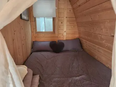 a sauna with a towel and candles and a bottle of wine at Cabane Sauna & Jacuzzi Hiver in Vaccili