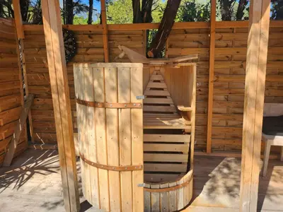a couple kissing in front of lit candles at Cabane Sauna & Jacuzzi Hiver in Vaccili