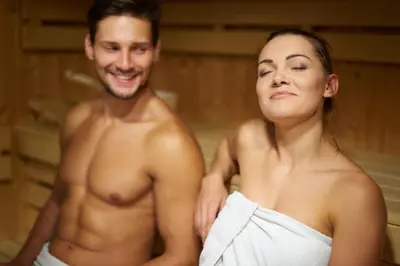 a man and a woman standing in a bath tub at Cabane Sauna & Jacuzzi Hiver in Vaccili