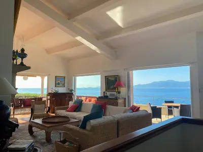 a living room with a view of the ocean at Burgundian House By The Sea In Corsica in Coti-Chiavari
