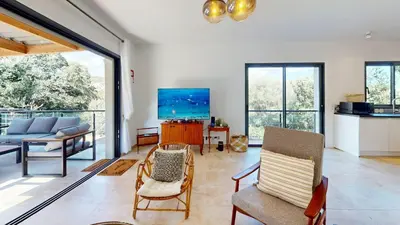 a living room with a couch and a tv at Villa With Pool Between Porto-Vecchio And Bonifacio in Sotta