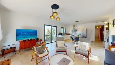 a living room with a tv and a table and chairs at Villa With Pool Between Porto-Vecchio And Bonifacio in Sotta
