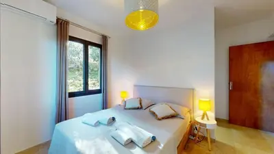 a bedroom with a bed with towels on it at Villa With Pool Between Porto-Vecchio And Bonifacio in Sotta
