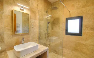 a bathroom with a sink and a glass shower at Villa With Pool Between Porto-Vecchio And Bonifacio in Sotta