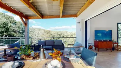 a living room with a table and a television at Villa With Pool Between Porto-Vecchio And Bonifacio in Sotta