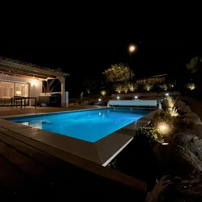 a swimming pool at night in a backyard at Villa With Pool Between Porto-Vecchio And Bonifacio in Sotta