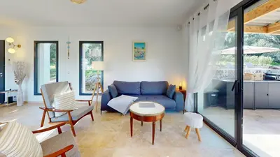 a living room with a blue couch and a table at Villa With Pool Between Porto-Vecchio And Bonifacio in Sotta