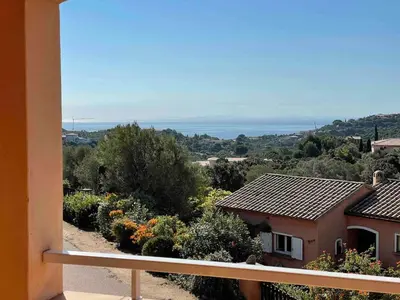 a view from a balcony of a house with flowers at Maison Bon Aria familiale vue mer 5 min plages in Porto-Vecchio