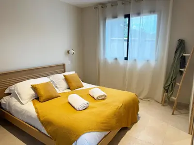 a bedroom with a bed with yellow sheets and pillows at Résidence A Me Vita - Villas avec piscine privée à Porto-Vecchio in San-Gavino-di-Carbini