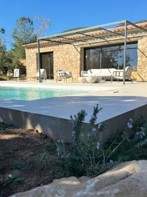 a living room with a couch and a table at Résidence A Me Vita - Villas avec piscine privée à Porto-Vecchio in San-Gavino-di-Carbini