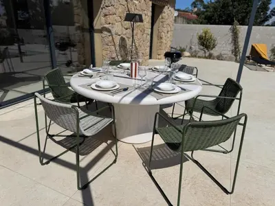 a person sitting on a bench next to a swimming pool at Résidence A Me Vita - Villas avec piscine privée à Porto-Vecchio in San-Gavino-di-Carbini