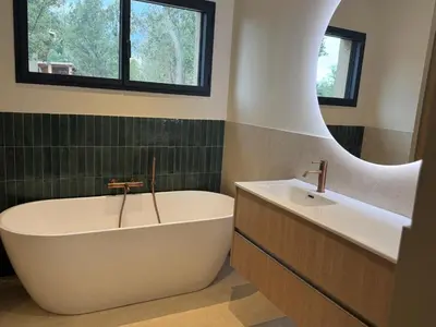 a kitchen with a large island with a table and chairs at Résidence A Me Vita - Villas avec piscine privée à Porto-Vecchio in San-Gavino-di-Carbini