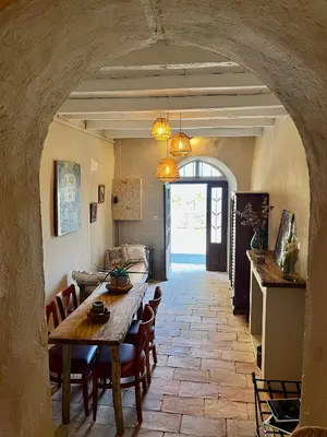 a kitchen and dining room with a table and chairs at Magnifique Duplex au coeur de Cargèse in Cargèse