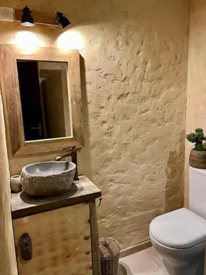 a bathroom with a sink and a toilet at Magnifique Duplex au coeur de Cargèse in Cargèse