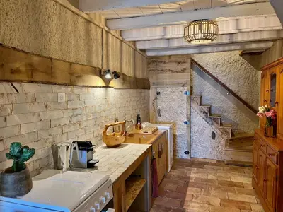 a kitchen with a counter and a sink and a staircase at Magnifique Duplex au coeur de Cargèse in Cargèse