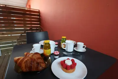 a table with a plate of croissants and strawberries on it at U Bellu - Modernité et calme à deux pas de la mer in Lecci
