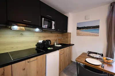 a kitchen with a sink and a counter top at U Bellu - Modernité et calme à deux pas de la mer in Lecci