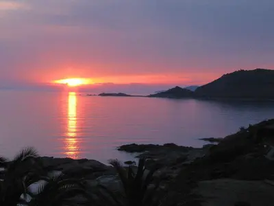 a sunset over a body of water at APPARTEMENT Vue MER TIUCCIA in Casaglione