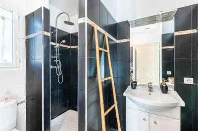 a bathroom with a shower and a toilet and a sink at Villa Valle Pace Maria - Piscine Privée in Afa