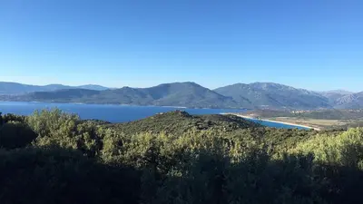 a view of a large body of water with mountains at Maison de Charme Vue Exceptionnelle Mer & Montagne in Campomoro