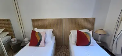 two beds with pillows in a hotel room at Maison de Charme Vue Exceptionnelle Mer & Montagne in Campomoro